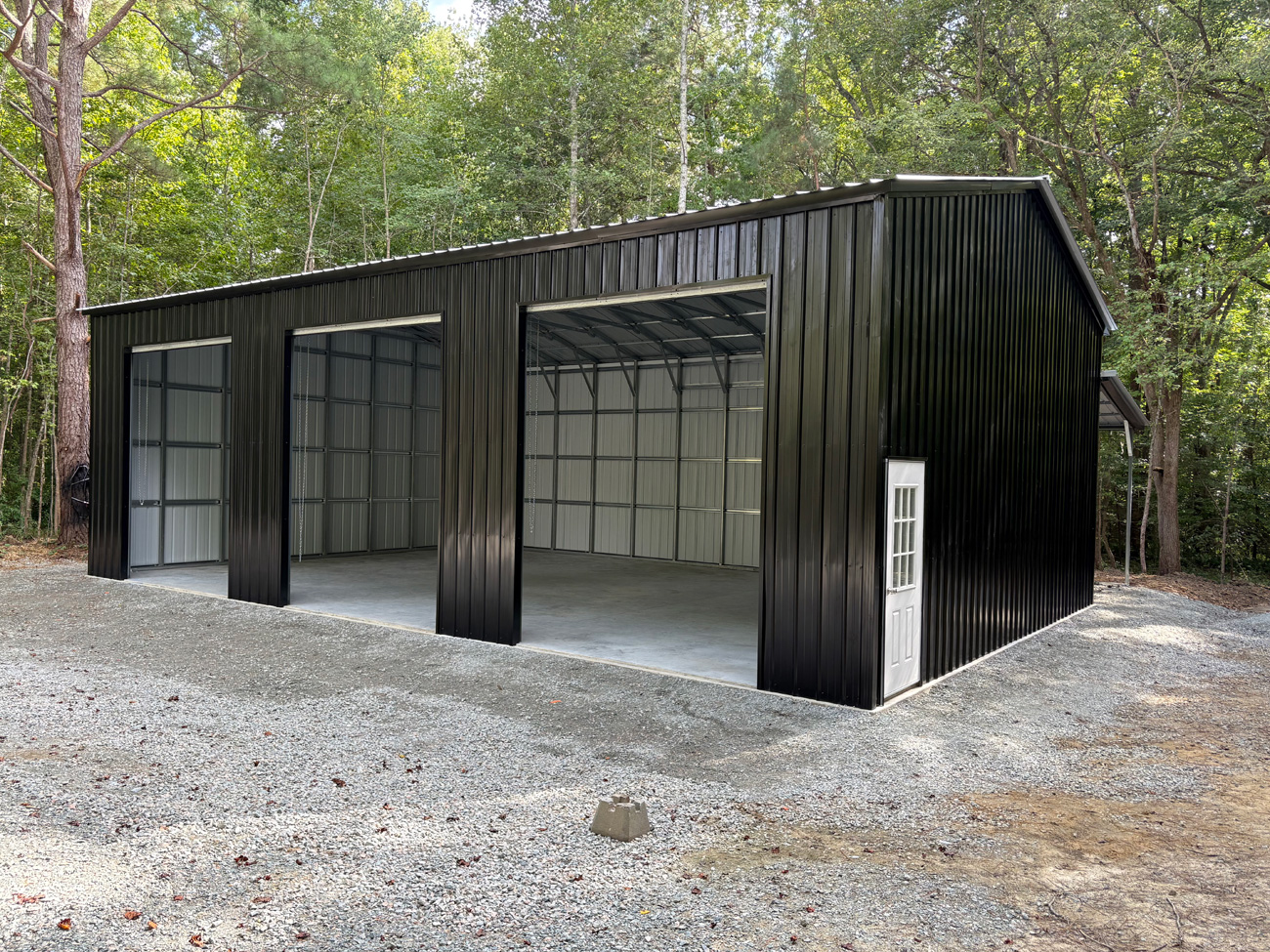 30' wide, 45' long, 14' tall metal garage with vertical metal roof and vertical metal siding and a 12' x 25' x 10' lean to